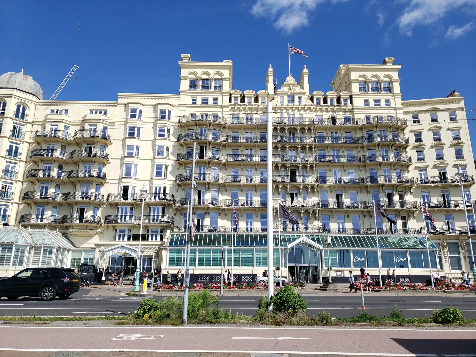 The Grand Hotel on King's Road, Brighton, seen from the seafront cycle lane, with the glass-fronted conservatory along its ground floor