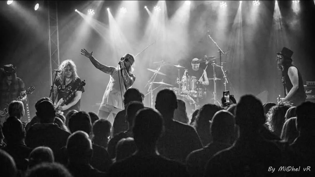 The Guns N Roses Experience on stage in black and white, with the crowd in the foreground
